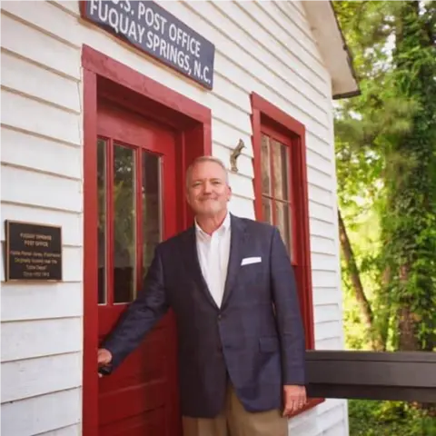 A profile picture of John B. Adcock.